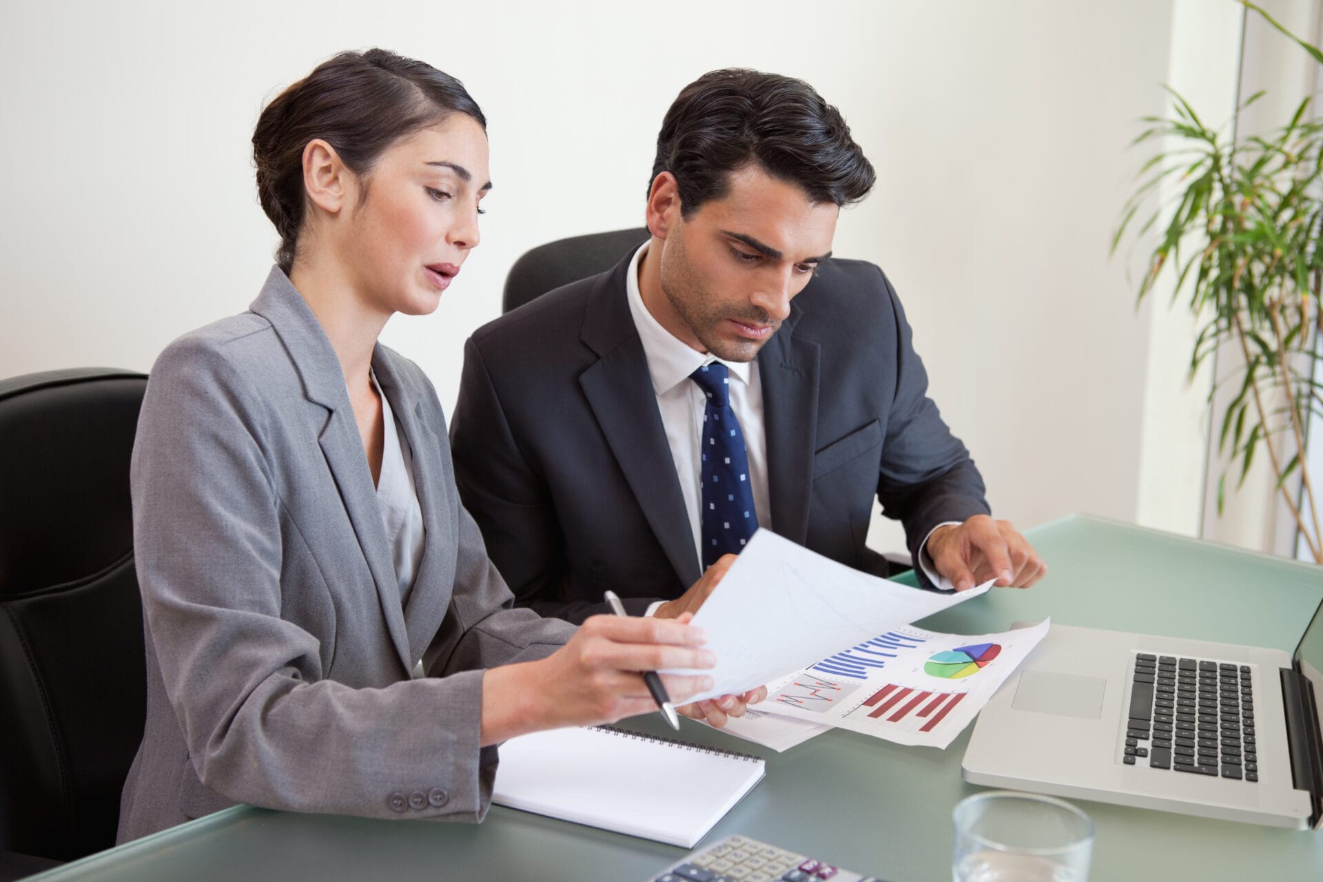 Sales persons working with a notebook